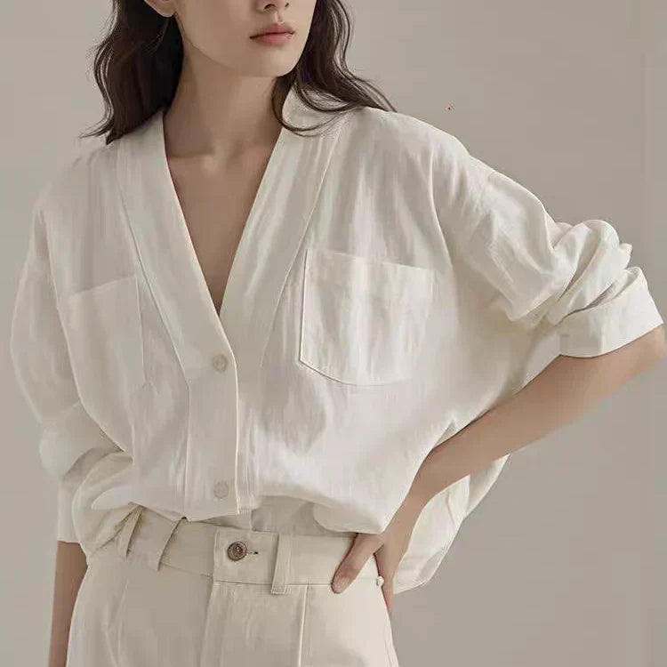 Woman wearing a casual white V-neck shirt, demonstrating styles for How to Sew a V-neck Shirt.