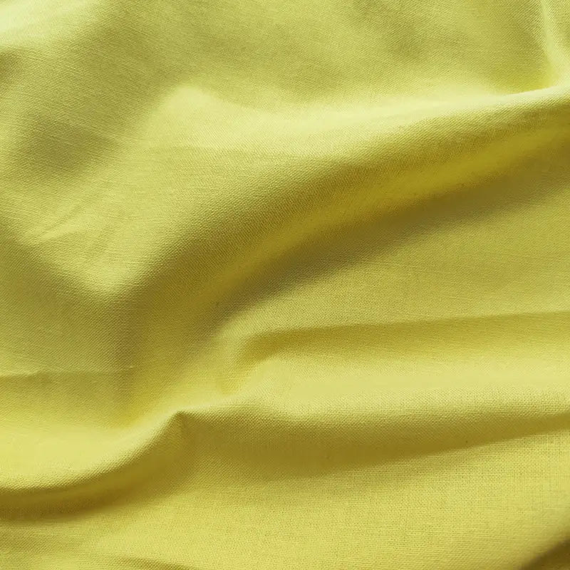 A close-up of Longan craft Light Weight Plain Ramie Fabric by the yard showcases its smooth texture, breathable feel, and bright yellow color—perfect for spring/summer dresses, curtains, or upholstery. 54" wide soft solid ramie cotton.