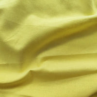 A close-up of Longan craft Light Weight Plain Ramie Fabric by the yard showcases its smooth texture, breathable feel, and bright yellow color—perfect for spring/summer dresses, curtains, or upholstery. 54" wide soft solid ramie cotton.