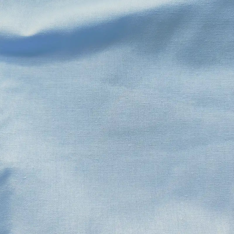 A close-up of Longan craft’s Light Weight Plain Ramie Fabric by the yard, 54" wide in soft pale blue, shows fine weave details and gentle shading across its breathable, sustainable cotton blend—ideal for dresses or curtains.