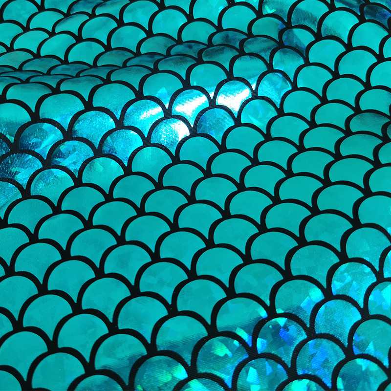 Close-up of Longan Craft’s Stretch Mermaid Fabric by the Yard—multicolor laser material with a repeating scale pattern, reflecting light for a shimmering mermaid effect; perfect stretchy fabric for costumes or crafts.