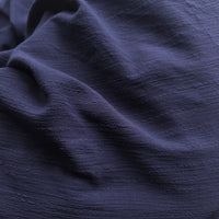 Close-up of dark blue fabric with visible texture