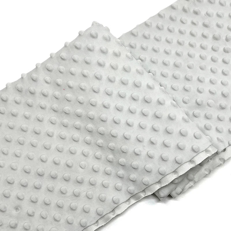 A folded piece of Longon Craft Dotted Minky Fabric By The Yard features a plush light gray surface with evenly spaced 3D dots, perfect for DIY craft sewing and projects.