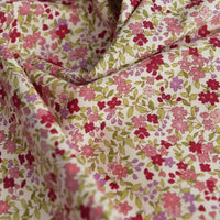 A close-up of Longan craft’s Floral Printed Poplin Fabric by the Yard, featuring small pink, red, and purple flowers with green leaves on light cotton—lightweight poplin material, perfect for quilting or dressmaking projects.