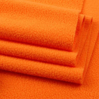Close-up of several folded pieces of Longon Craft Solid Polar Fleece Fabric By The Yard, a thick plain 100% polyester material ideal for cozy blankets, DIY sewing, crafts, and upholstery projects.