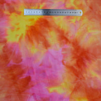 A metal ruler placed on Longon Craft’s Stretch Rainbow Minky Fabric by the yard, a gradient colorful floral fabric perfect for DIY plushies, toys, or clothing.