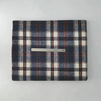 A folded piece of Multicolor Plaid Mammoth Flannel Fabric by Longan Craft is shown with a metal ruler for scale, set on a light gray background. This brushed polyester cotton flannelette is ideal for comfy shirts.
