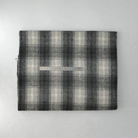 A piece of Longan Craft Multicolor Plaid Mammoth Flannel Fabric by the yard is shown in black, gray, and white with a ruler placed across for scale—brushed polyester cotton flannelette ideal for comfy shirts.