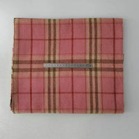 A folded piece of Longan Craft Multicolor Plaid Mammoth Flannel Fabric by the yard is displayed on a white surface, with a 20 cm metal ruler across the brushed polyester cotton textile for scale.
