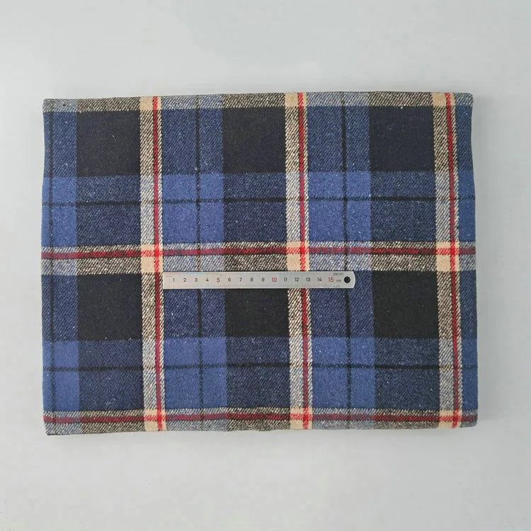 A Multicolor Plaid Mammoth Flannel Fabric by Longan Craft is displayed flat on a light surface, with a 20cm ruler across its center for scale. This brushed polyester cotton textile is ideal for comfy shirts and sold by the yard.