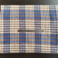 The Longan Craft Multicolor Plaid Mammoth Flannel Fabric By The Yard, a soft brushed polyester cotton textile for shirts, is displayed flat with a blue, brown, and white design. A silver 20cm ruler lies across the material.