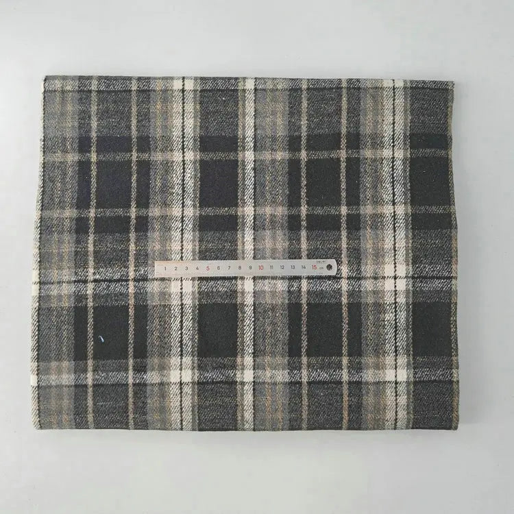 A neatly folded Longan Craft Multicolor Plaid Mammoth Flannel Fabric By The Yard, a brushed polyester-cotton textile for shirts, is shown with a ruler for scale against a light background.