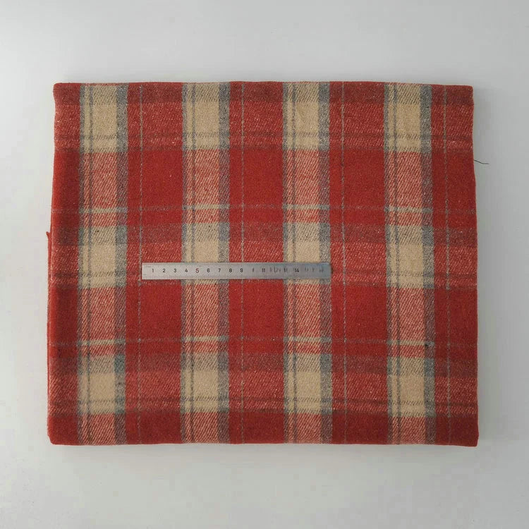 A folded piece of Longan Craft Multicolor Plaid Mammoth Flannel Fabric By The Yard, a brushed polyester cotton flannelette for shirts, is displayed flat with a metal ruler on top for scale against a plain white background.