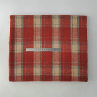 A folded piece of Longan Craft Multicolor Plaid Mammoth Flannel Fabric By The Yard, a brushed polyester cotton flannelette for shirts, is displayed flat with a metal ruler on top for scale against a plain white background.