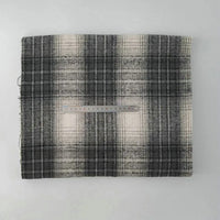 A piece of Longan Craft Multicolor Plaid Mammoth Flannel Fabric By The Yard is folded on a white surface with a transparent 20-cm ruler placed across its center for scale, showcasing the comfy brushed polyester cotton textile.