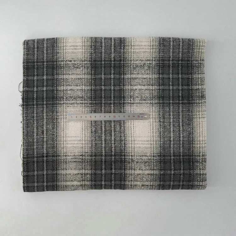 A piece of Longan Craft Multicolor Plaid Mammoth Flannel Fabric By The Yard is folded on a white surface with a transparent 20-cm ruler placed across its center for scale, showcasing the comfy brushed polyester cotton textile.