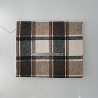 A folded Longan Craft Multicolor Plaid Mammoth Flannel Fabric by the yard, a brushed polyester-cotton blend for shirts, is shown with a metal ruler for scale against a light gray background.