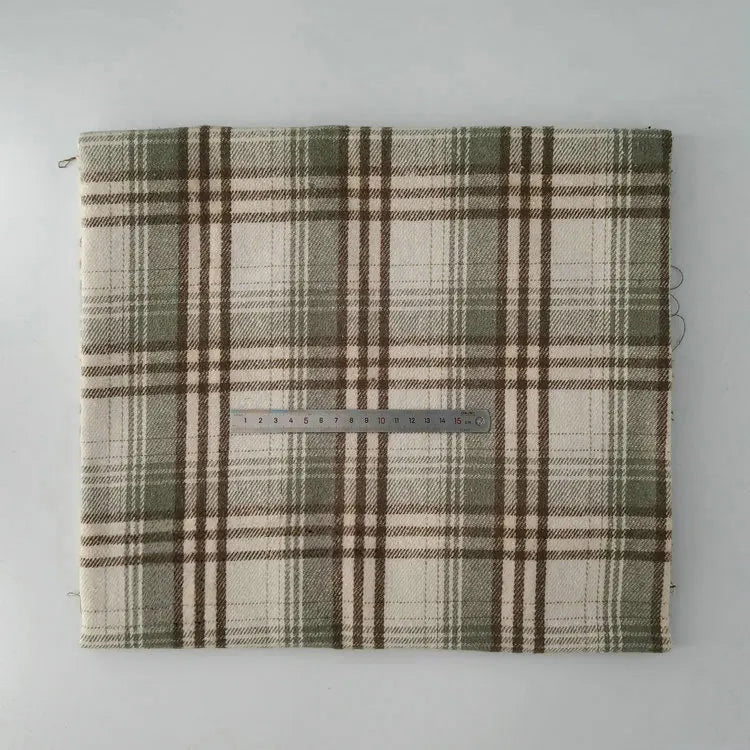 A piece of Longan Craft Multicolor Plaid Mammoth Flannel Fabric By The Yard, a comfy brushed polyester-cotton textile for shirts, lies flat with a ruler across the center for scale.