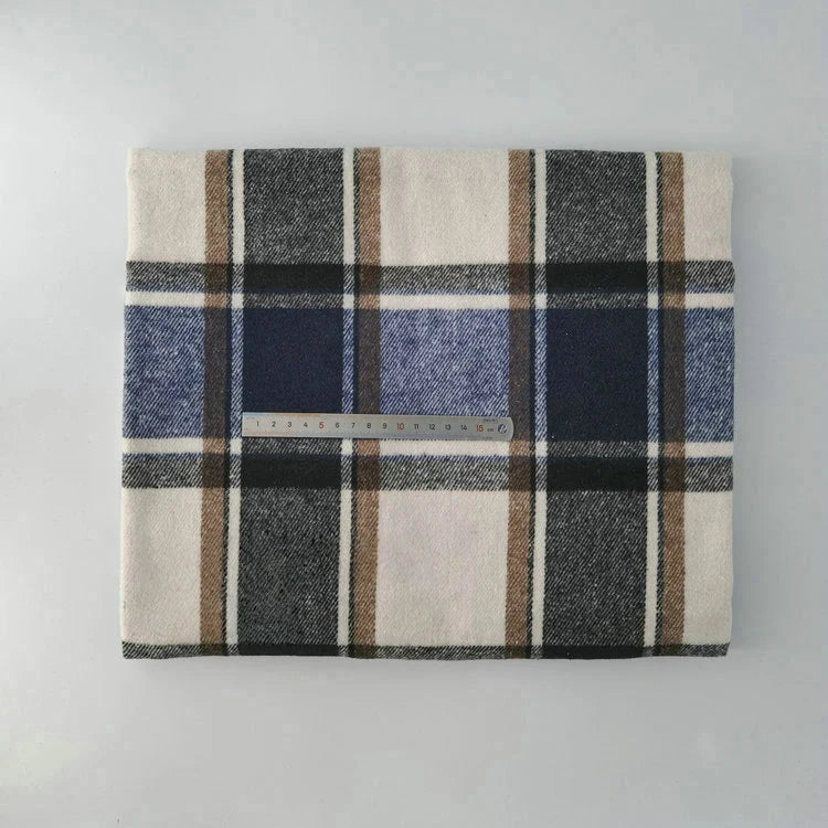 Multicolor Plaid Mammoth Flannel Fabric by the yard from Longan Craft, featuring black, brown, blue, and white stripes, is shown folded with a clear ruler for scale on a light background. Brushed polyester-cotton flannelette for shirts.