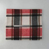The Multicolor Plaid Mammoth Flannel Fabric by Longan Craft is a red, black, brown, and white brushed polyester cotton textile for shirts, shown folded with a ruler on a light gray surface.