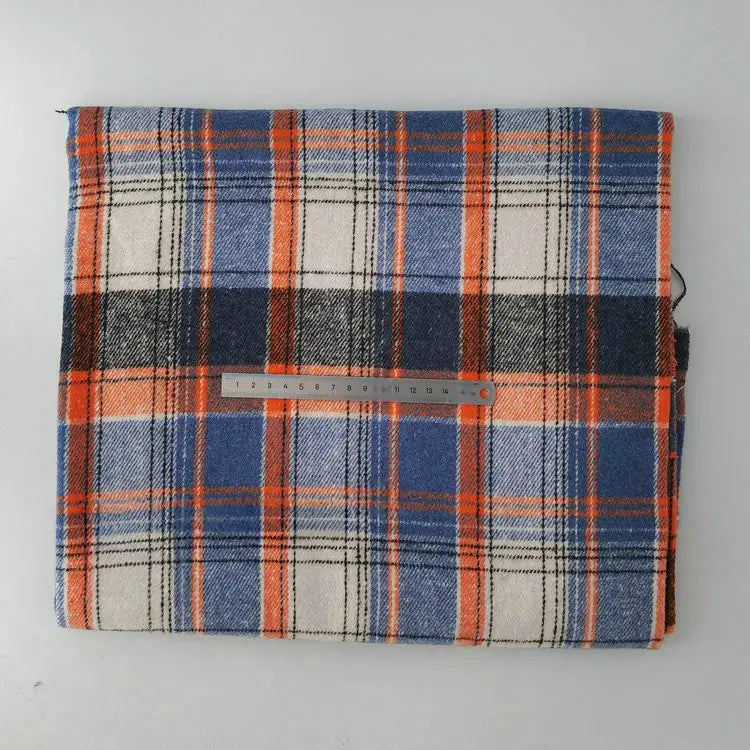 A piece of Longan Craft Multicolor Plaid Mammoth Flannel Fabric by the yard, a soft brushed polyester-cotton textile ideal for shirts, is shown folded with a metal ruler on top for scale against a plain light background.