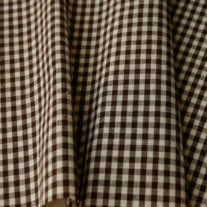 Close-up of Longan Craft’s 100% Cotton Gingham Poplin Fabric by the yard, featuring a brown and white multicolor yarn-dyed checkered pattern, with premium soft folds and subtle shadows—ideal for garment making.