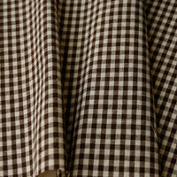 Close-up of Longan Craft’s 100% Cotton Gingham Poplin Fabric by the yard, featuring a brown and white multicolor yarn-dyed checkered pattern, with premium soft folds and subtle shadows—ideal for garment making.