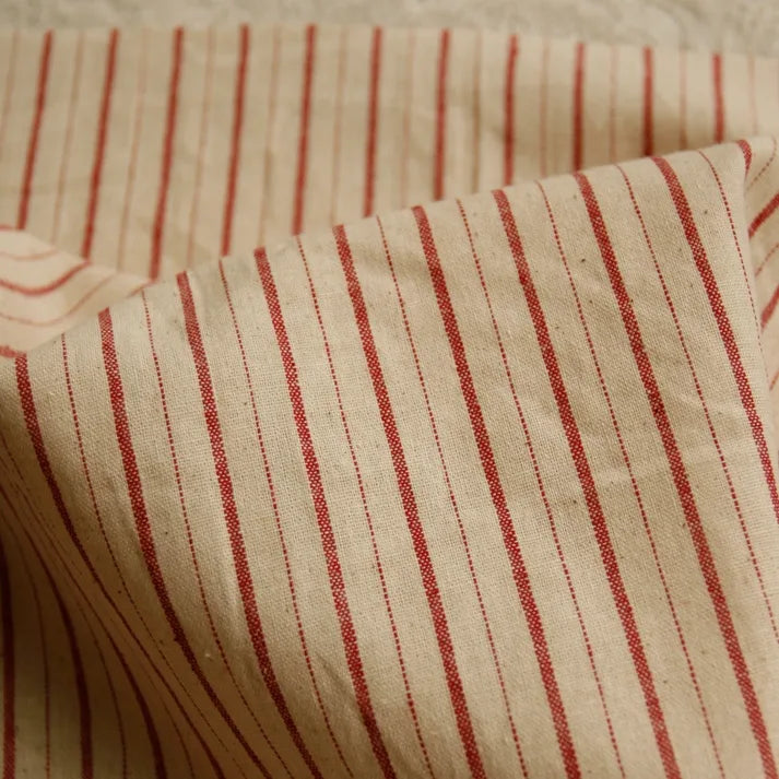 A close-up of Longan Craft’s 100% cotton gingham poplin fabric by the yard, featuring multicolor yarn-dyed checkered patterns. The premium soft poplin material is gently folded and slightly wrinkled, highlighting its texture and subtle shadows—perfect for garment making.
