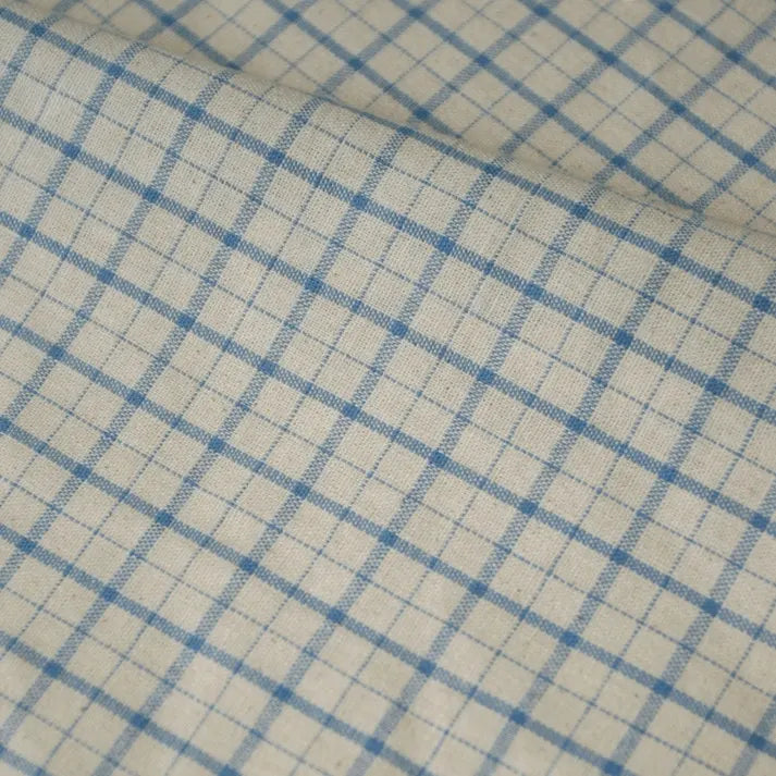 A close-up of the Longan Craft 100% Cotton Gingham Poplin Fabric by the yard reveals a multicolor yarn-dyed checkered pattern, featuring intersecting blue horizontal and vertical lines that form small squares on a beige background. The premium soft poplin material has a slightly wrinkled surface, ideal for garment making.