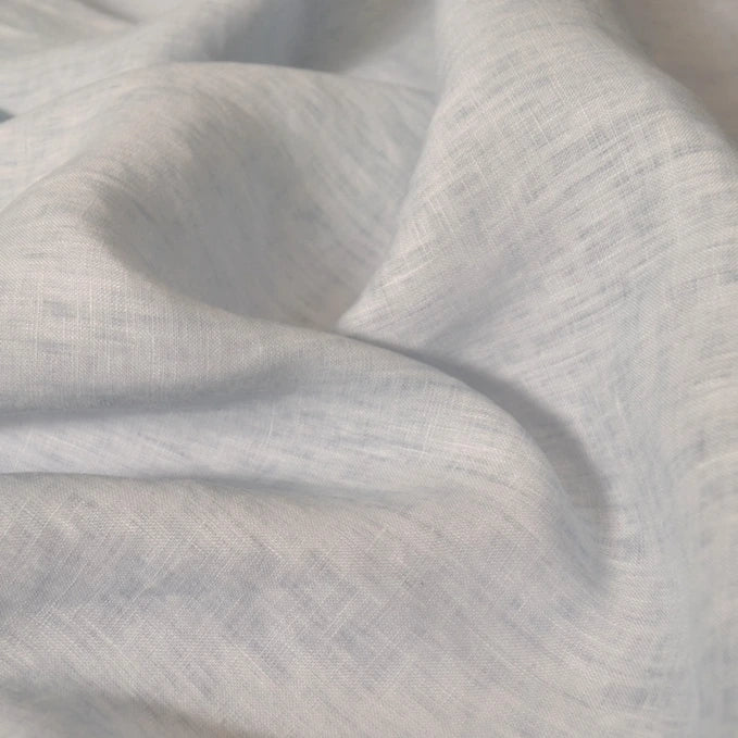 A close-up of Longan Craft’s 100% Linen Fabric By The Yard in light grey or off-white, showing its soft, lightweight texture and visible weave—ideal for summer projects seeking comfort with a sustainable touch.