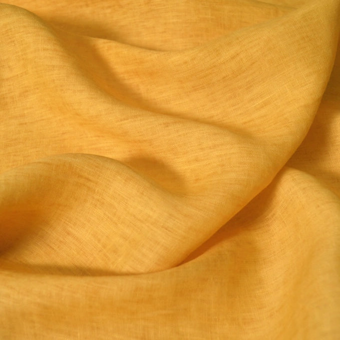 A close-up of Longan Craft’s 100% linen fabric by the yard in light yellow, showcasing its soft, lightweight, and slightly sheer texture with smooth folds—perfect as a comfortable summer linen material.