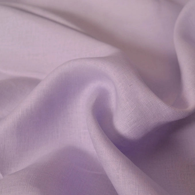 Close-up of Longan Craft's 100 Linen Fabric By The Yard in light purple, showing its soft, flowing, and slightly translucent lightweight texture—ideal as a comfortable solid color material for summer projects.