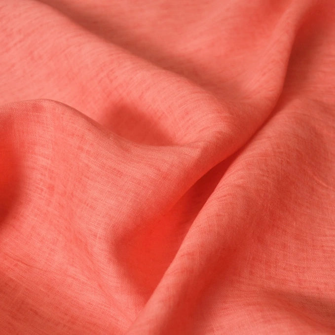 Close-up of Longan Craft’s 100% Linen Fabric By The Yard, a solid coral-colored, lightweight linen material with visible weave texture—ideal for comfortable summer projects.