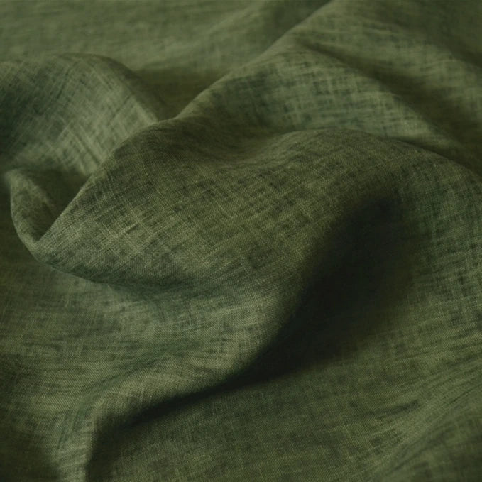 Close-up of Longan Craft's 100% linen fabric by the yard in olive green, featuring a visible weave pattern, gentle folds, and soft shadows—perfect as a solid color lightweight and breathable summer material.