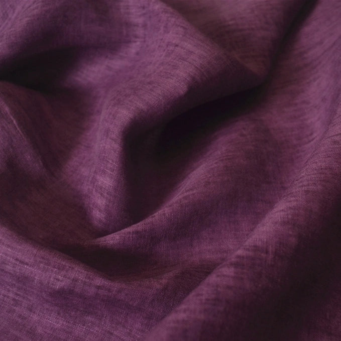 A close-up of Longan Craft's 100 Linen Fabric By The Yard in deep purple, highlighting its lightweight, textured weave and soft, slightly wrinkled surface—perfect for comfortable summer garments.