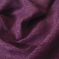 A close-up of Longan Craft's 100 Linen Fabric By The Yard in deep purple, highlighting its lightweight, textured weave and soft, slightly wrinkled surface—perfect for comfortable summer garments.