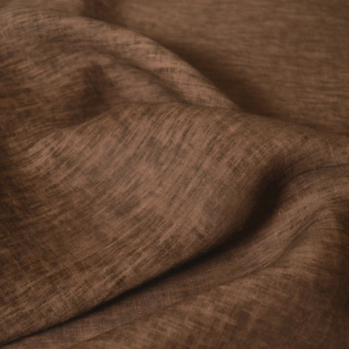 A close-up of Longan Craft’s 100 Linen Fabric By The Yard in solid color, gently draped to display its soft folds and lightweight texture—perfect for comfortable summer projects.