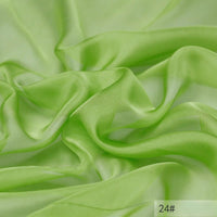 The Longan Craft 100 Mulberry Silk Chiffon Fabric By The Yard is a lightweight, translucent material in light green with a flowing texture and label 24# in the corner—ideal for colorful dresses.
