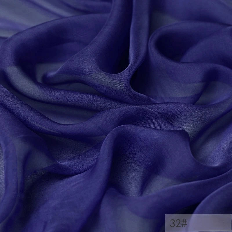 A close-up of Longan Craft’s 100% Mulberry Silk Chiffon Fabric By The Yard—lightweight, sheer, and flowing chiffon in deep purple. This colorful chiffon material is perfect for dresses, catching light to showcase its delicate texture and depth.