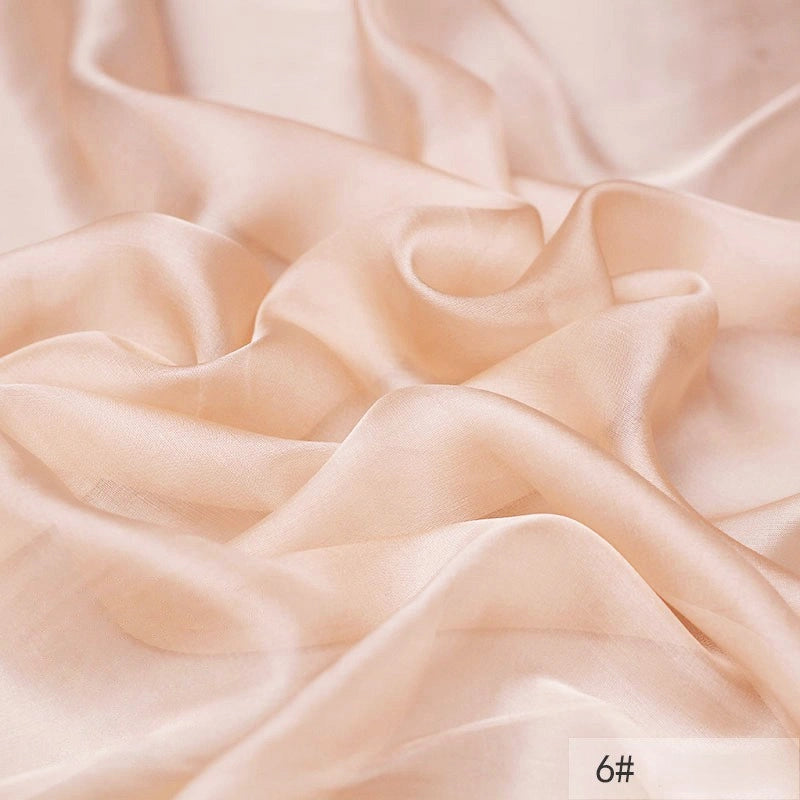 A close-up of smooth, light peach 100 Mulberry Silk Chiffon Fabric by Longan Craft with gentle folds and a soft, flowing texture. The number 6# appears in the bottom right corner. Perfect lightweight material for dresses.