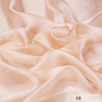 A close-up of smooth, light peach 100 Mulberry Silk Chiffon Fabric by Longan Craft with gentle folds and a soft, flowing texture. The number 6# appears in the bottom right corner. Perfect lightweight material for dresses.
