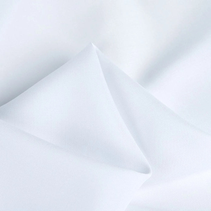 A close-up of Longan Craft’s 100 Rayon Fabric By The Yard shows soft folds and gentle shadows, highlighting the smooth, breathable texture of this solid color viscose dressmaking material.