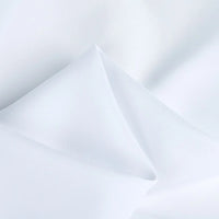 A close-up of Longan Craft’s 100 Rayon Fabric By The Yard shows soft folds and gentle shadows, highlighting the smooth, breathable texture of this solid color viscose dressmaking material.