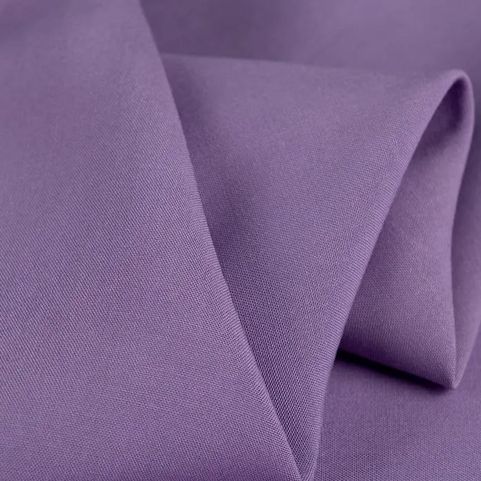 Close-up of smooth, folded Longan Craft 100 Rayon Fabric in lavender, highlighting its silky-soft texture and fine weave—perfect lightweight, breathable viscose material for dressmaking by the yard.
