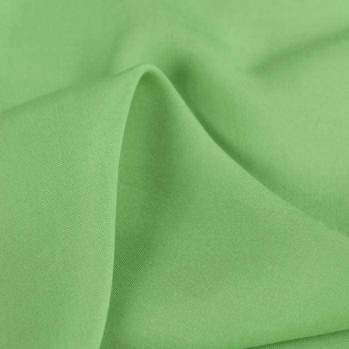 A close-up of Longan Craft 100% Rayon Fabric by the Yard shows its smooth, soft, lightweight viscose texture and gentle folds—perfect for dressmaking and clothing projects.