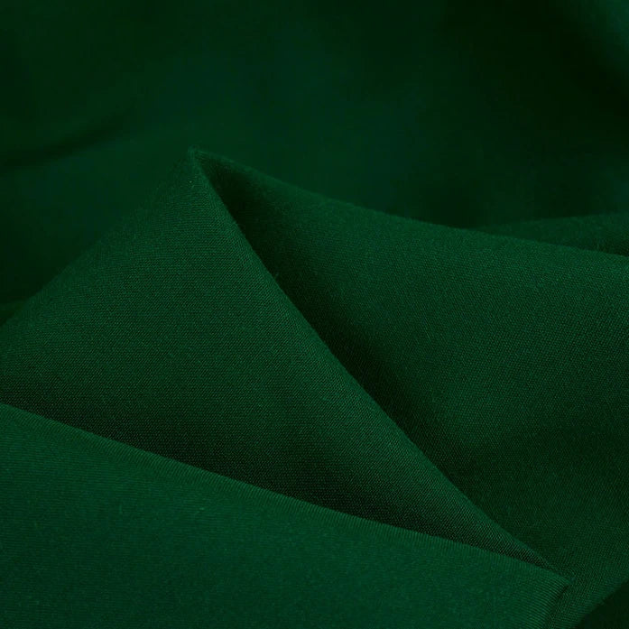 A close-up of Longan Craft’s 100 Rayon Fabric By The Yard in dark green, a silky-smooth, soft, solid color viscose perfect for dressmaking and clothing.