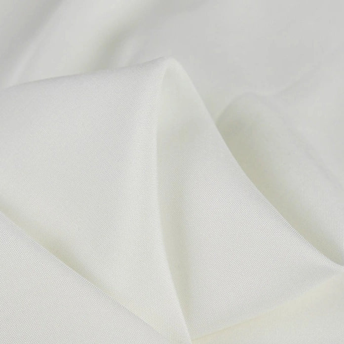 A close-up of Longan Craft’s 100 Rayon Fabric By The Yard shows its soft, solid color viscose material with a smooth texture and gentle folds—ideal as breathable, elegant dressmaking fabric for refined comfort.
