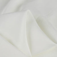 A close-up of Longan Craft’s 100 Rayon Fabric By The Yard shows its soft, solid color viscose material with a smooth texture and gentle folds—ideal as breathable, elegant dressmaking fabric for refined comfort.