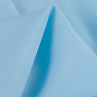 A close-up of Longan Craft's 100 Rayon Fabric By The Yard reveals its soft, silky-smooth texture with a gentle sheen and subtle folds. This solid color viscose material is lightweight, breathable, and ideal for dressmaking projects.