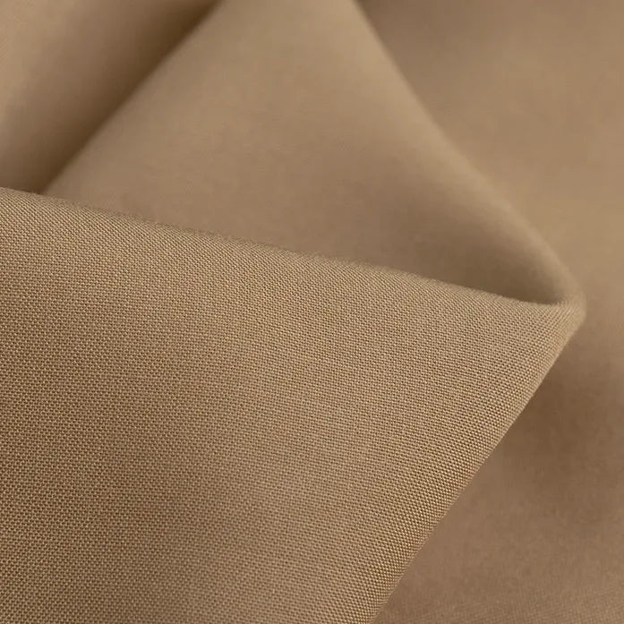Close-up of Longan Craft’s 100 Rayon Fabric By The Yard, showing its light brown, breathable viscose with a smooth texture, fine matte weave, and soft folds—ideal for dressmaking and garment projects.